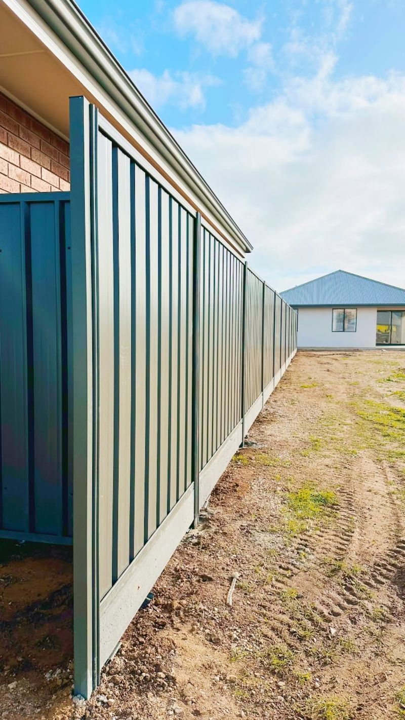 Two-tone Colorbond fence in sage green and dark grey